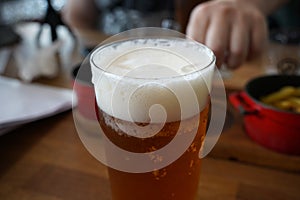 Czech-style Pilsner lager golden beer on table of bar pub restaurant in Prague, Czech Republic