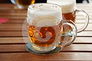 Czech-style Pilsner lager golden beer on table of bar pub restaurant in Prague, Czech Republic