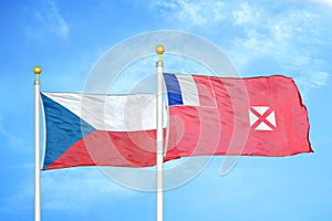 Czech and Wallis and Futuna two flags on flagpoles and blue cloudy sky