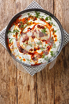 CÃÂ±lbÃÂ±r is a Turkish egg dish reminiscent of a poached egg. prepared with yoghurt, garlic served with melted butter soaked in photo