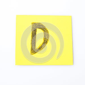 D alphabet letter handwrite on a yellow paper