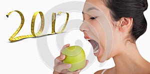 3D Composite image of woman biting into apple