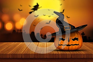 3D Halloween pumpkin on a wooden table with defocussed spooky im