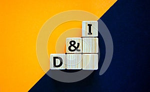 D and I, Diversity and inclusion symbol. Concept words D and I, diversity and inclusion on wooden cubes on beautiful black and