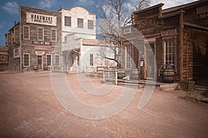 3D illustration of an empty street in an old wild west town with wooden buildings