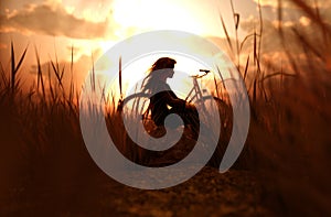 Girl sitting alone in grass field