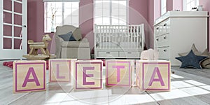 The name aleta written with wooden toy cubes in children`s room photo
