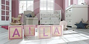The name alia written with wooden toy cubes in children`s room photo