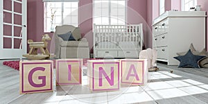 The name gina written with wooden toy cubes in children`s room photo