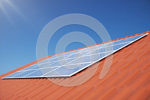 3D illustration solar panels on a red roof of a house. Solar panels with reflection beautiful blue sky. Concept of