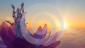 a translucent multi-armed goddess sitting against the background of the dawn sky