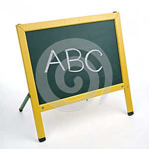 Yellow chalkboard with ABC isolated on white background photo