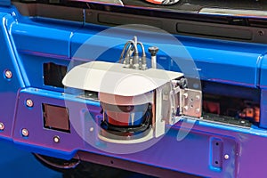 2D LiDAR sensor on the front bumper of an unmanned vehicle, close-up. An part of the self-driving system of the truck photo