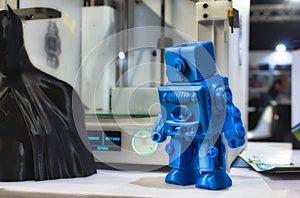 3D printed robot model next to a 3d printer