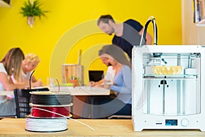 3D Printer With Designers In Background