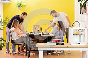 3D Printer Machine With Designers In Background