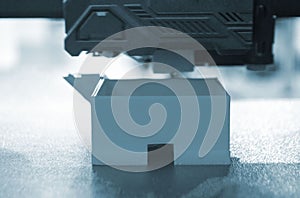 3D printer prints object. The process of printing model on 3D printer Blue color
