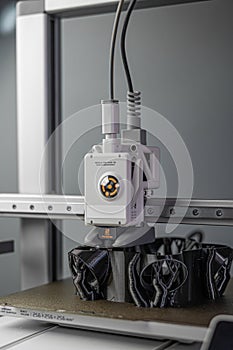 3D printer prints an object. The process of printing model on 3D printer. Model printed on 3D printer from molten