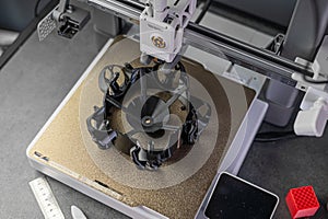 3D printer prints an object. The process of printing model on 3D printer. Model printed on 3D printer from molten