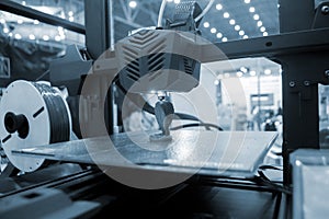 3D printer working close-up 3D printer prints a model from molten plastic