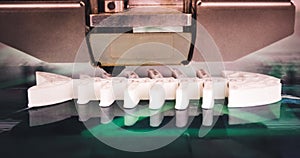 3D printer working and creating an object from the hot molten plastic