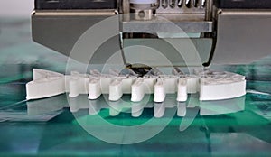 3D printer working and creating an object from the hot molten plastic