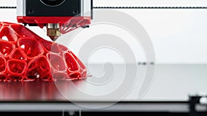 3D printing complex red geometric shape.