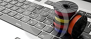 3D printing software. ABS filaments on a laptop keyboad. 3d illustration
