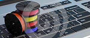 3D printing software. ABS filaments on a laptop keyboad. 3d illustration