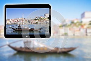 3D render concept image with a digital tablet showing a typical portuguese wooden boats, called Barcos Rabelos, used in the past photo