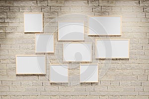 3D render illustration of multi size blank photo frames on the sand block bright wall. Empty picture frame mockup