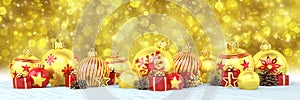 3d render - golden and red christmas baubles over bokeh background - panorama