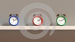 3D render - three multi-colored alarm clocks stand on a shelf. The alarms show the time of New York, Moscow and Tokyo