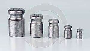 3D rendering of different size of metal calibration weight on color background
