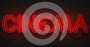 3D rendering flickering blinking red neon sign on dark brick background, cinema movie film entertainment sign photo