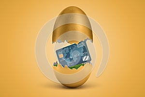 3d rendering of gold egg cracked in two, upper half levitating in air, plastic credit card on green grass in lower half.