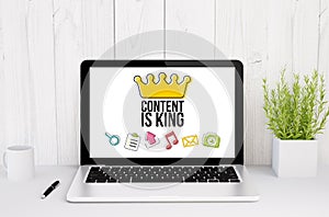 laptop on table content is king