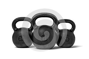 3d rendering of three black iron kettlebells with markings 32, 24 and 16 kg standing close to each other. photo