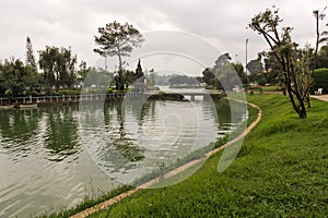 A view of the green golf course across the Ho Xuan Huong lake in the hill town of Dalat