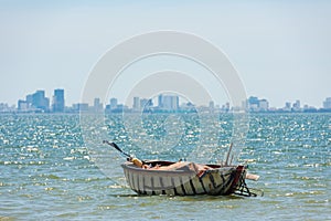 Da Nang city in silhouette with lonely basket boat