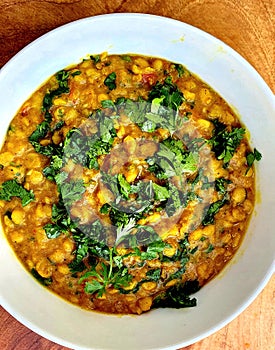 Daal curry.Traditional pakistani and Indian cuisine.Served in a white bowl.Chopped coriander is sprinkled on it.