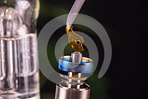 Dabbing tool with small piece of cannabis oil aka shatter - medical marijuana concentrates concept