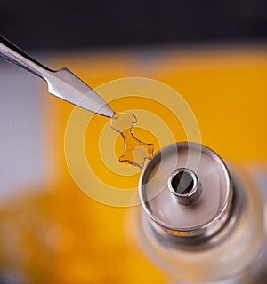 Dabbing tool with small piece of cannabis oil aka shatter - medical marijuana concentrates concept