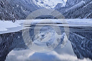 Dachstein mountain reflected in Vorderer Gosausee on a snowy winter day