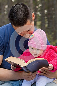 Dad and Baby Daughter Reading Bible photo