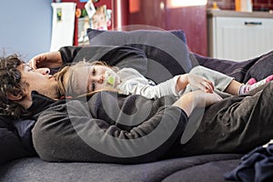 Dad and baby girl relaxing on the sofa