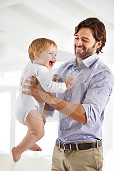 Dad, baby and laughing while playing, bonding and love at home for child development and growth. Father, parent and