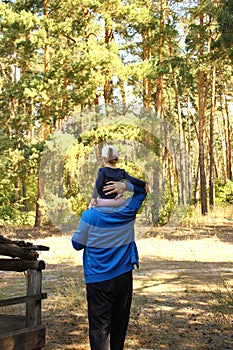 Dad carries a daughter on his shoulders