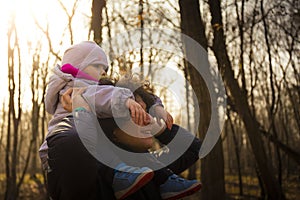 Dad carrying his baby on his shoulders in forest