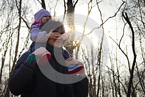 Dad carrying his baby on his shoulders in forest